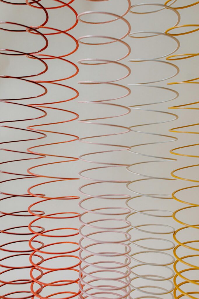 Colorful spiral patterns in red, pink, and yellow create a lively abstract backdrop.