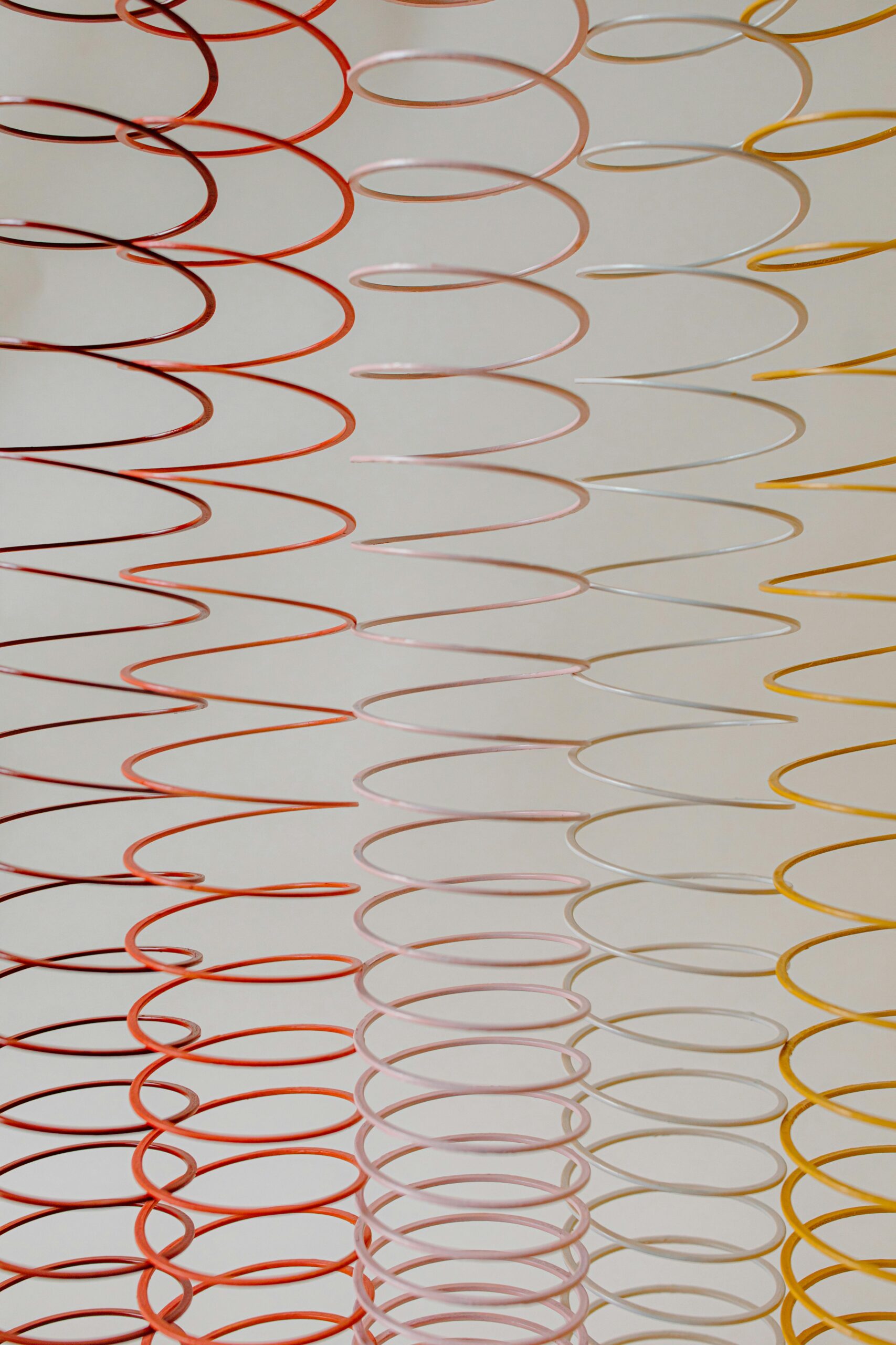 Colorful spiral patterns in red, pink, and yellow create a lively abstract backdrop.